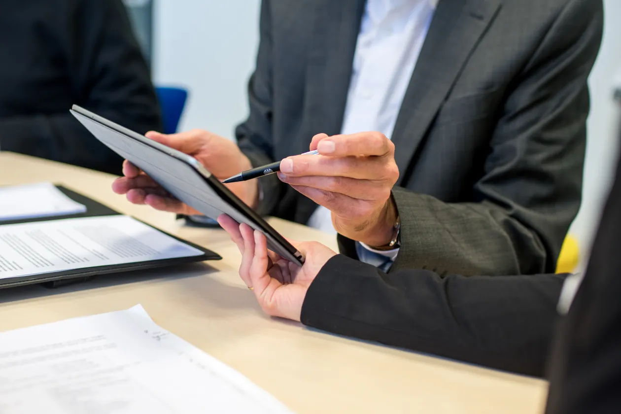 Man points on tablet.