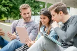 Three students work with tablets