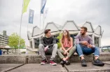 Studierende sitzen am Campus.