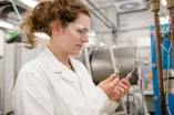 Young researcher looking at components