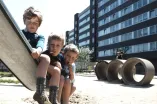 Kinder sitzen auf einem Spielplatz in der Hustadt in den 1970er-Jahren.
