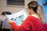 Photo: Young woman looking at a plan.