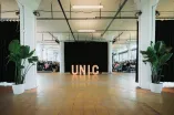 Photo: Luminous UNIC logo on the floor at an event.