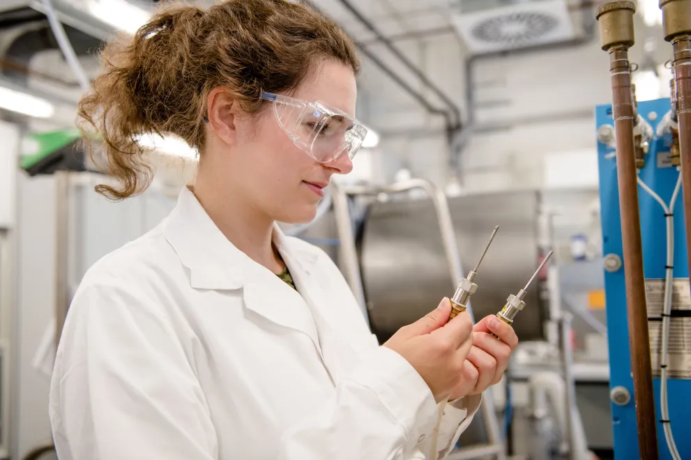 Young researcher looking at components