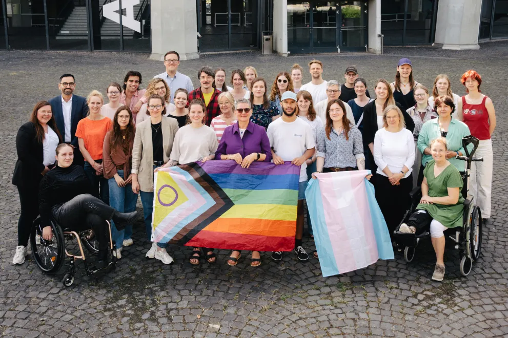 Gruppenfoto aller Akteure der RUB, die sich für Diversität engagieren, mit Diversityflaggen